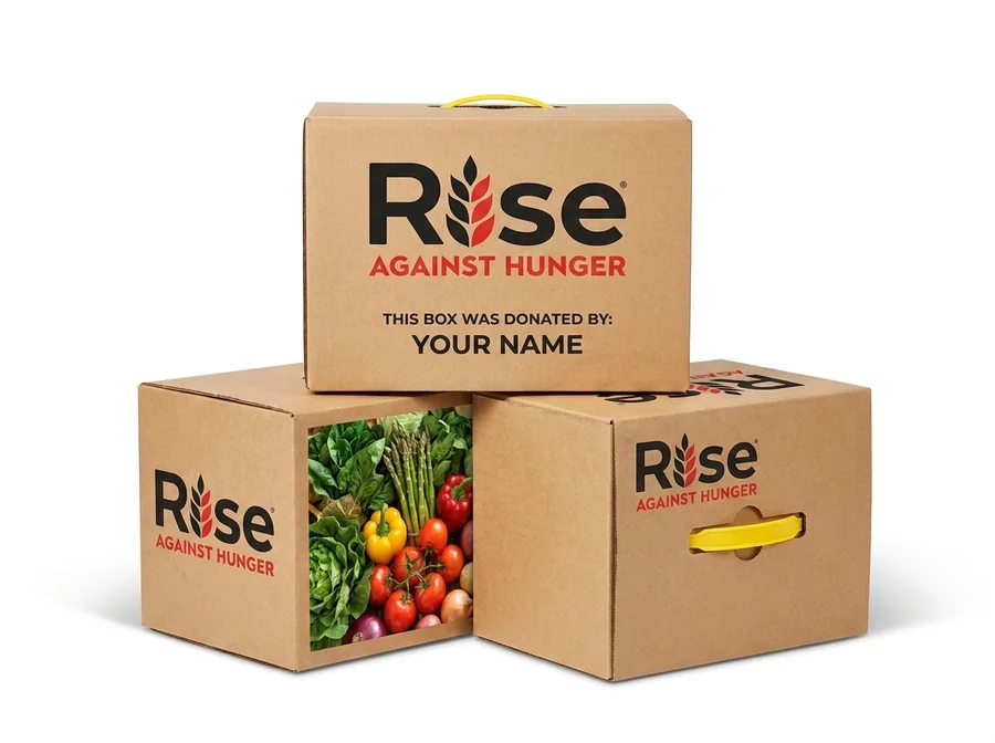 Three Rise Against Hunger meal boxes, the top one printed: This box was donated by your name